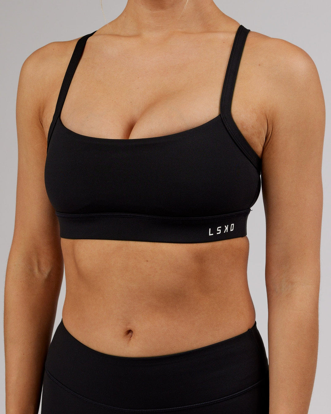 Woman wearing Momentum Sports Bra - Black