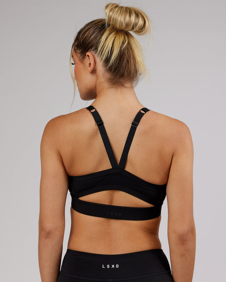 Woman wearing Momentum Sports Bra - Black
