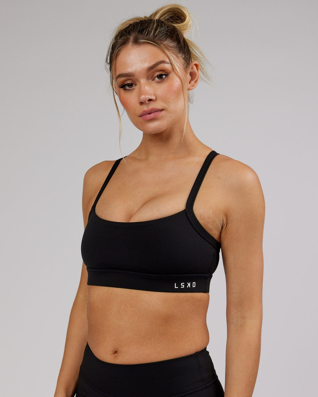 Woman wearing Momentum Sports Bra - Black