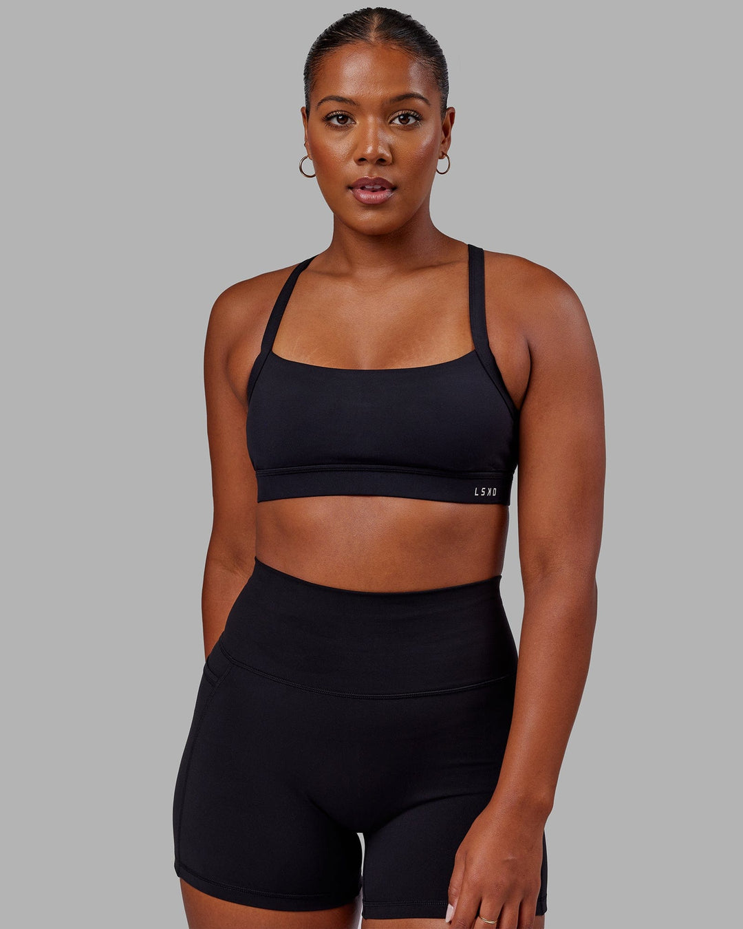 Woman wearing Momentum Sports Bra - Black