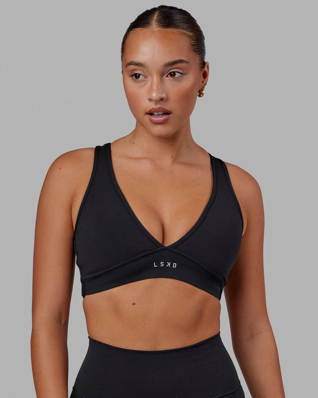 Woman wearing Stamina Sports Bra in Black | Size:S