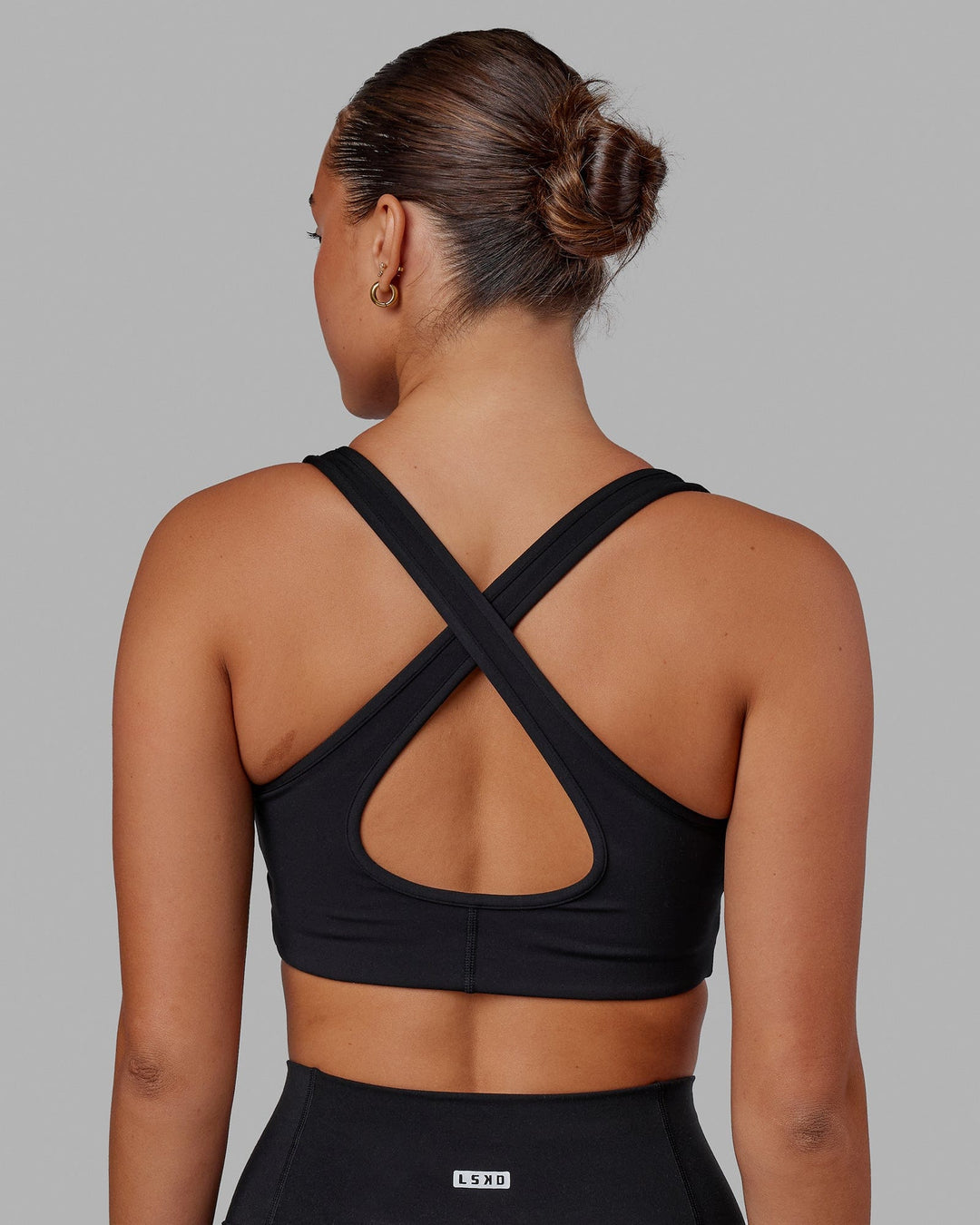 Woman wearing Stamina Sports Bra in Black | Size:S