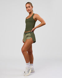 Woman wearing Accelerate 3" Mid-Rise Running Short - Pure Olive-Fog | Model:Xs | Size:ISSY | Thumbnail Index: 8