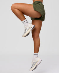 Woman wearing Accelerate 3" Mid-Rise Running Short - Pure Olive-Fog | Model:Xs | Size:ISSY | Thumbnail Index: 14