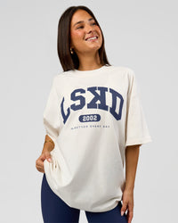 Woman wearing Varsity EST Heavyweight Oversized Tee  - Off White-Future Navy | Model:Bianca | Size:L | Thumbnail Index: 2