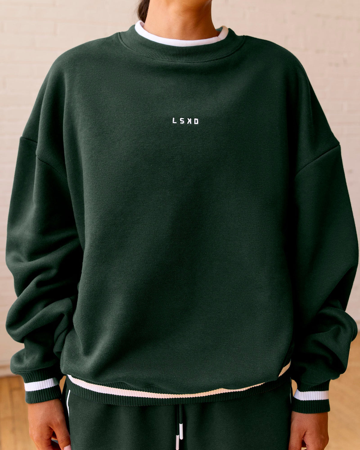 Woman wearing Go-To Dual Oversized Sweater - Midnight Green-White | Model:Meg | Size:M
