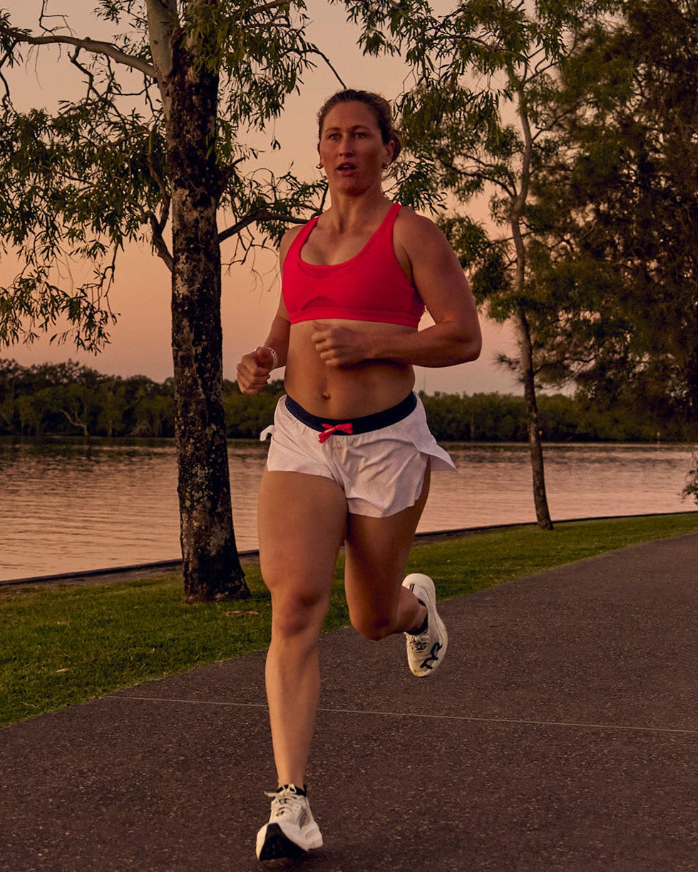 Woman wearing Accelerate 3" Mid-Rise Running Short - White-Future Navy | Model:Tia | Size:M