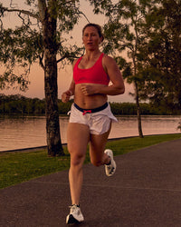 Woman wearing Accelerate 3" Mid-Rise Running Short - White-Future Navy | Model:Tia | Size:M | Thumbnail Index: 0