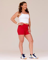 Woman wearing Fusion Ultra High-Rise 6" Short Pockets - Scarlet | Model:Tia | Size:M | Thumbnail Index: 0