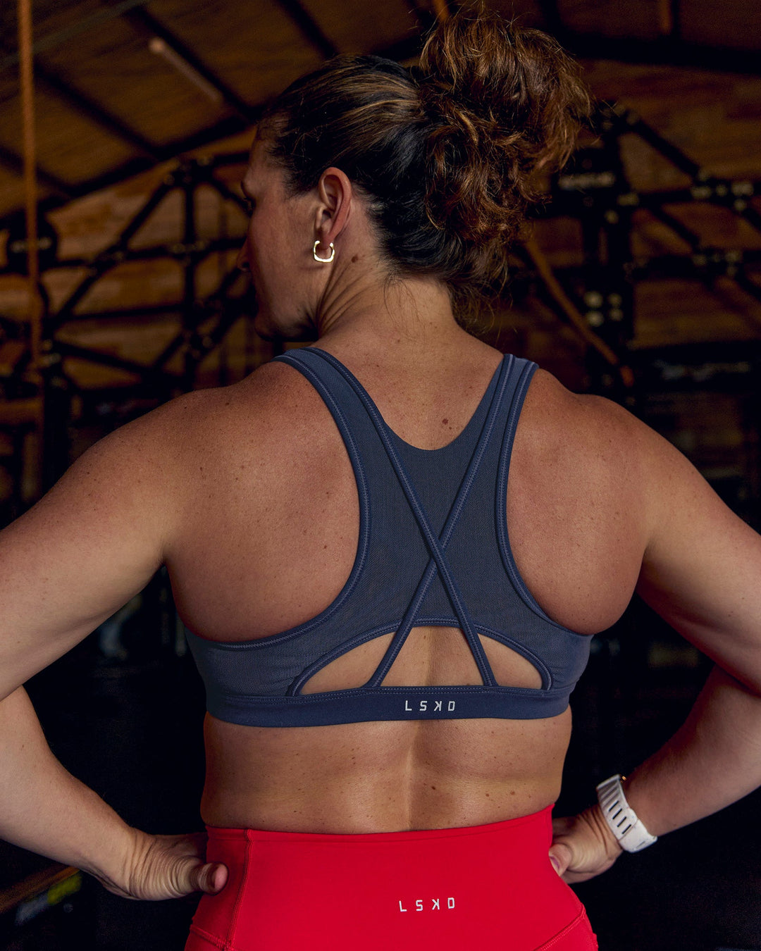 Woman wearing Unstoppable Racerback Sports Bra - Future Navy | Model:Tia | Size:M - view 1