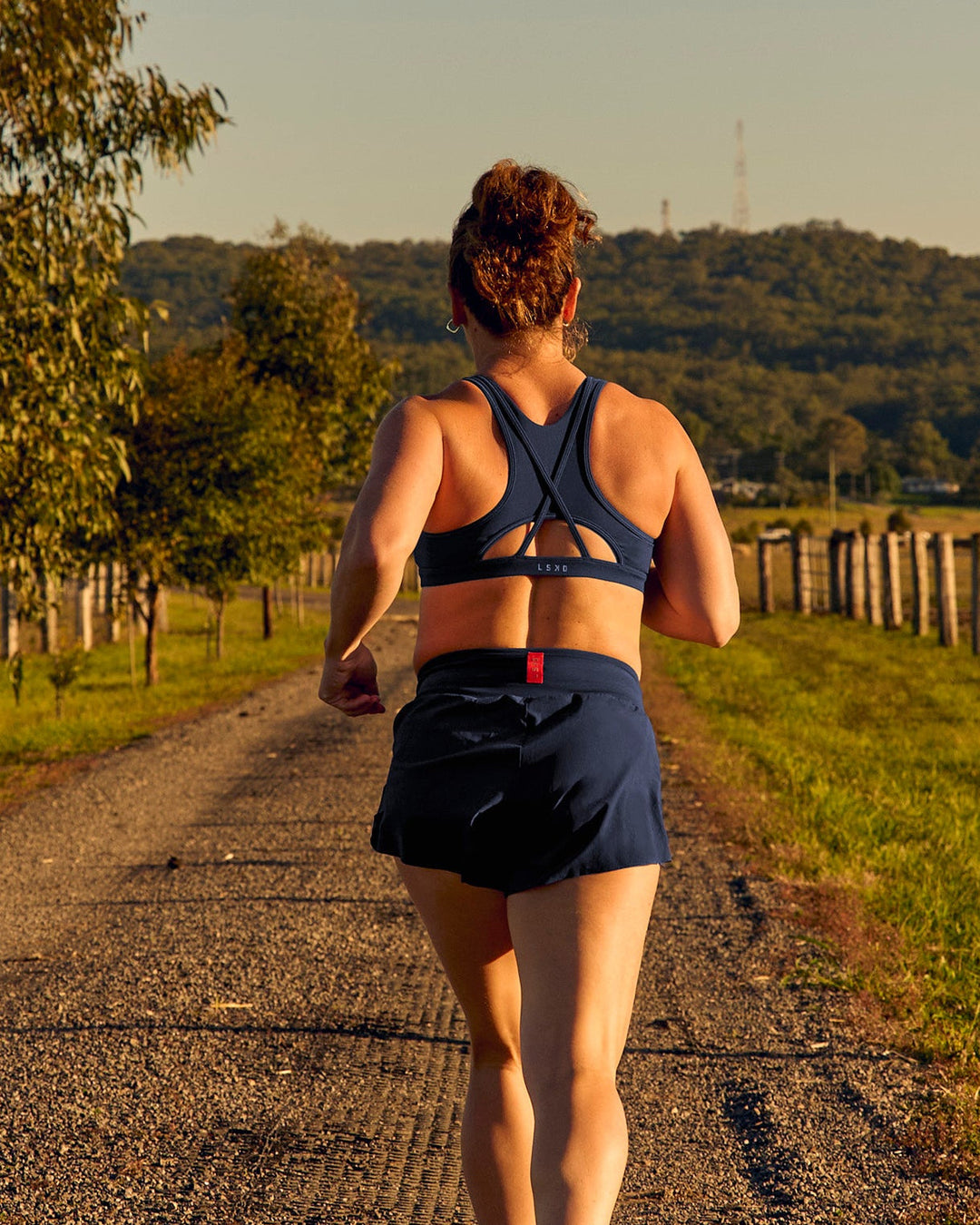 Woman wearing Unstoppable Racerback Sports Bra - Future Navy | Model:Tia | Size:M - view 5
