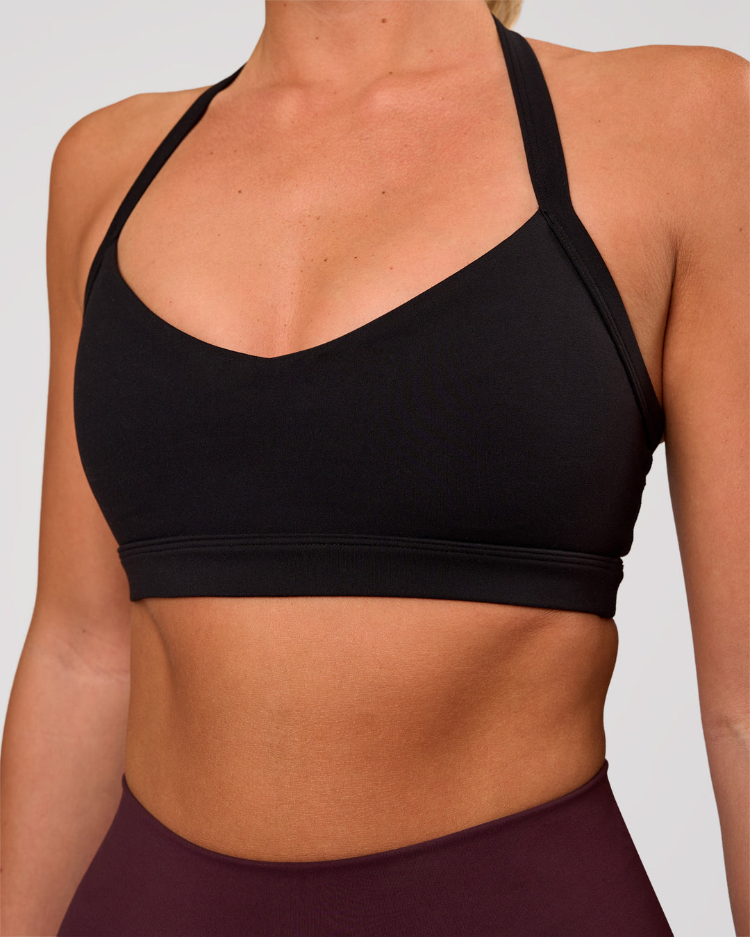Woman wearing Unleash Sports Bra - Black | Model:Amity | Size:S - view 1