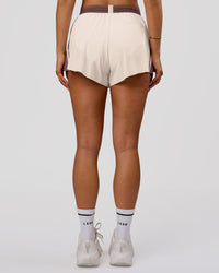 Woman wearing Accelerate 3" Force High-Rise Running Short - Cocoa Powder-Off White | Model:Bianca | Size:S | Thumbnail Index: 1