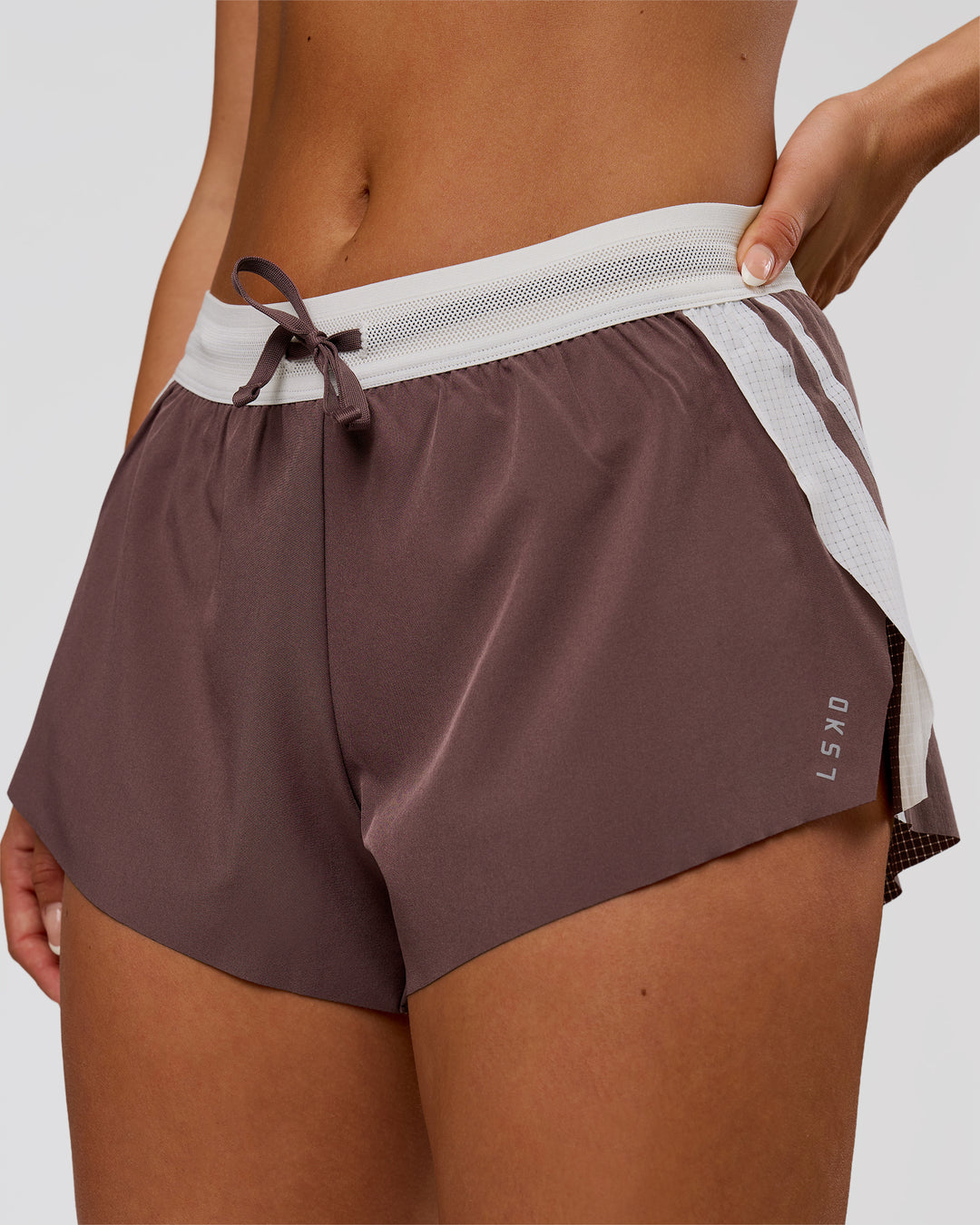 Woman wearing Accelerate 3" Force Mid-Rise Running Short - Cocoa Powder | Model:Bianca | Size:S - view 1