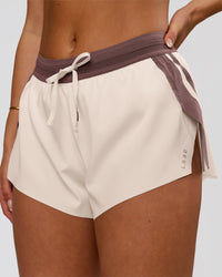 Woman wearing Accelerate 3" Force Mid-Rise Running Short - Cocoa powder-Off White | Model:Bianca | Size:S | Thumbnail Index: 0