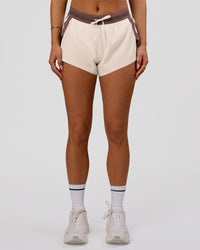 Woman wearing Accelerate 3" Force Mid-Rise Running Short - Cocoa powder-Off White | Model:Bianca | Size:S | Thumbnail Index: 3