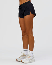 Woman wearing Accelerate 3" Mid-Rise Running Short - Black | Model:Bianca | Size:S