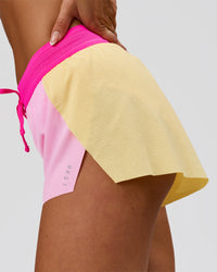 Woman wearing Accelerate 3" Mid-Rise Running Short - Marshmallow-Lemon-Ultra Pink | Model:Bianca | Size:S | Thumbnail Index: 3