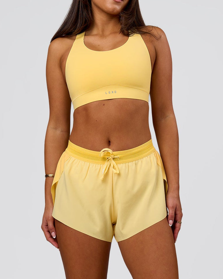 Woman wearing Accelerate 3" Mid-Rise Running Short - Sunbeam-Lemon | Model:Bianca | Size:S - view 2