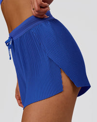 Woman wearing Accelerate 3" Pleated High-Rise Running Short - Power Cobalt | Model:Bianca | Size:S | Thumbnail Index: 6