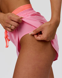 Woman wearing Accelerate Synergy 3" Running Short Short - Pink Rose-Hyper Orange | Model:Bianca | Size:S | Thumbnail Index: 1