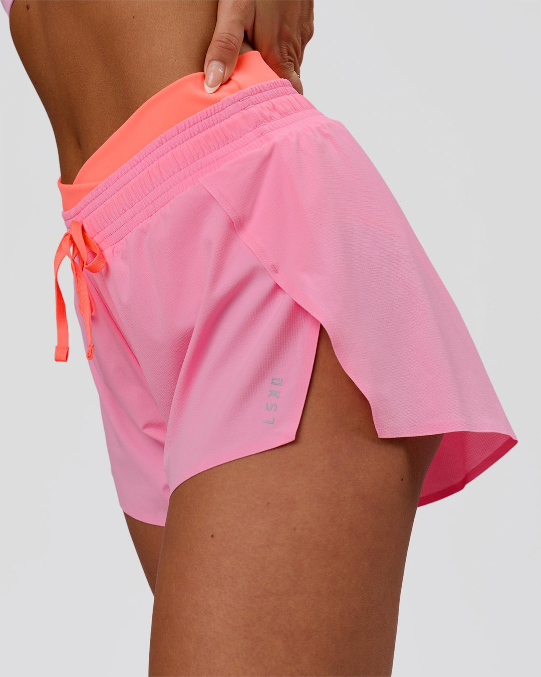 Woman wearing Accelerate Synergy 3" Running Short Short - Pink Rose-Hyper Orange | Model:Bianca | Size:S - view 3