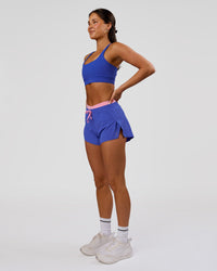 Woman wearing Accelerate Synergy 3" Running Short Short - Power Cobalt-Pink Rose | Model:Bianca | Size:S | Thumbnail Index: 5