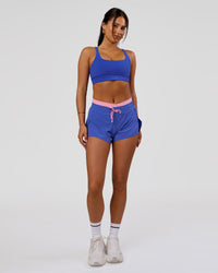 Woman wearing Accelerate Synergy 3" Running Short Short - Power Cobalt-Pink Rose | Model:Bianca | Size:S | Thumbnail Index: 11