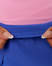 Woman wearing Accelerate Synergy 3" Running Short Short - Power Cobalt-Pink Rose | Model:Bianca | Size:S | Thumbnail Index: 14