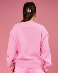 Woman wearing We Rise Oversized Sweater - Pink Rose-We Rise | Model:Bianca | Size:S | Thumbnail Index: 1