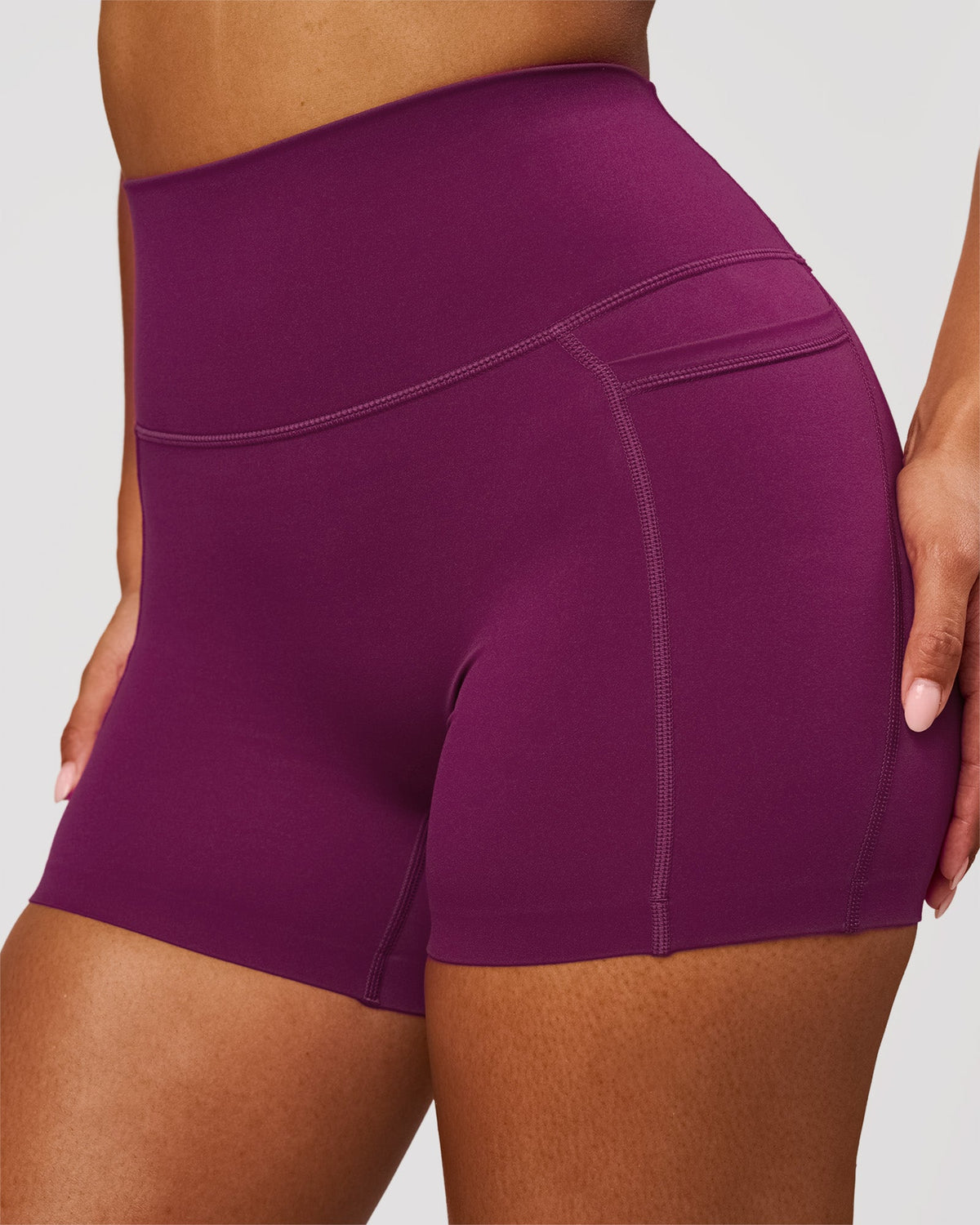 Woman wearing Elixir High-Rise 4" Short Pockets - Plum Caspia | Model:Jordan | Size:S - view 1