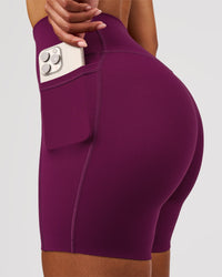 Woman wearing Elixir High-Rise 6" Short Pockets - Plum Caspia | Model:Jordan | Size:S | Thumbnail Index: 1