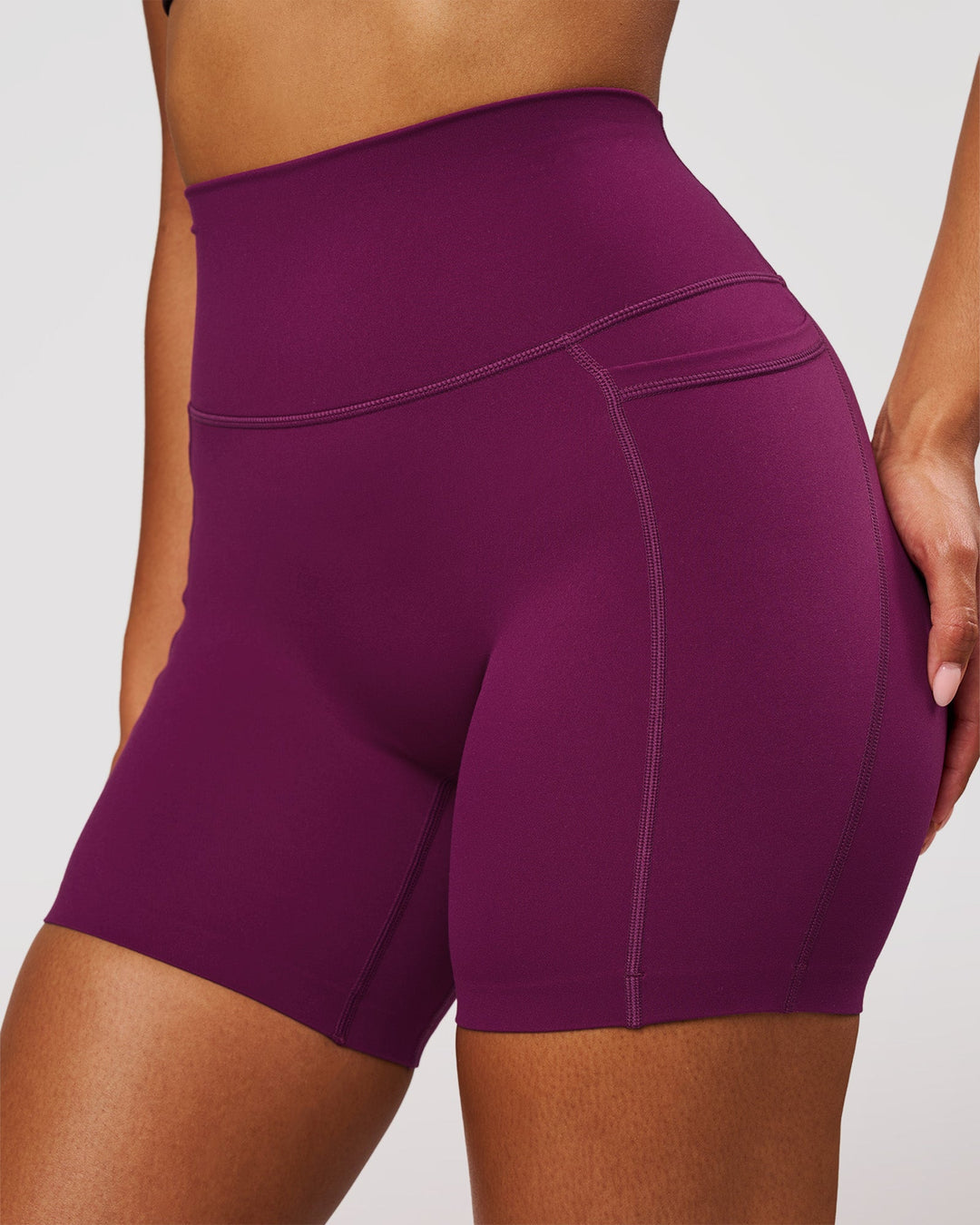 Woman wearing Elixir High-Rise 6" Short Pockets - Plum Caspia | Model:Jordan | Size:S - view 1