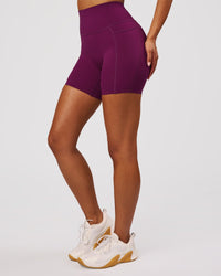 Woman wearing Elixir High-Rise 6" Short Pockets - Plum Caspia | Model:Jordan | Size:S | Thumbnail Index: 8