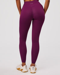 Woman wearing Elixir High-Rise Full Length Legging Pockets - Plum Caspia | Model:Jordan | Size:S | Thumbnail Index: 1