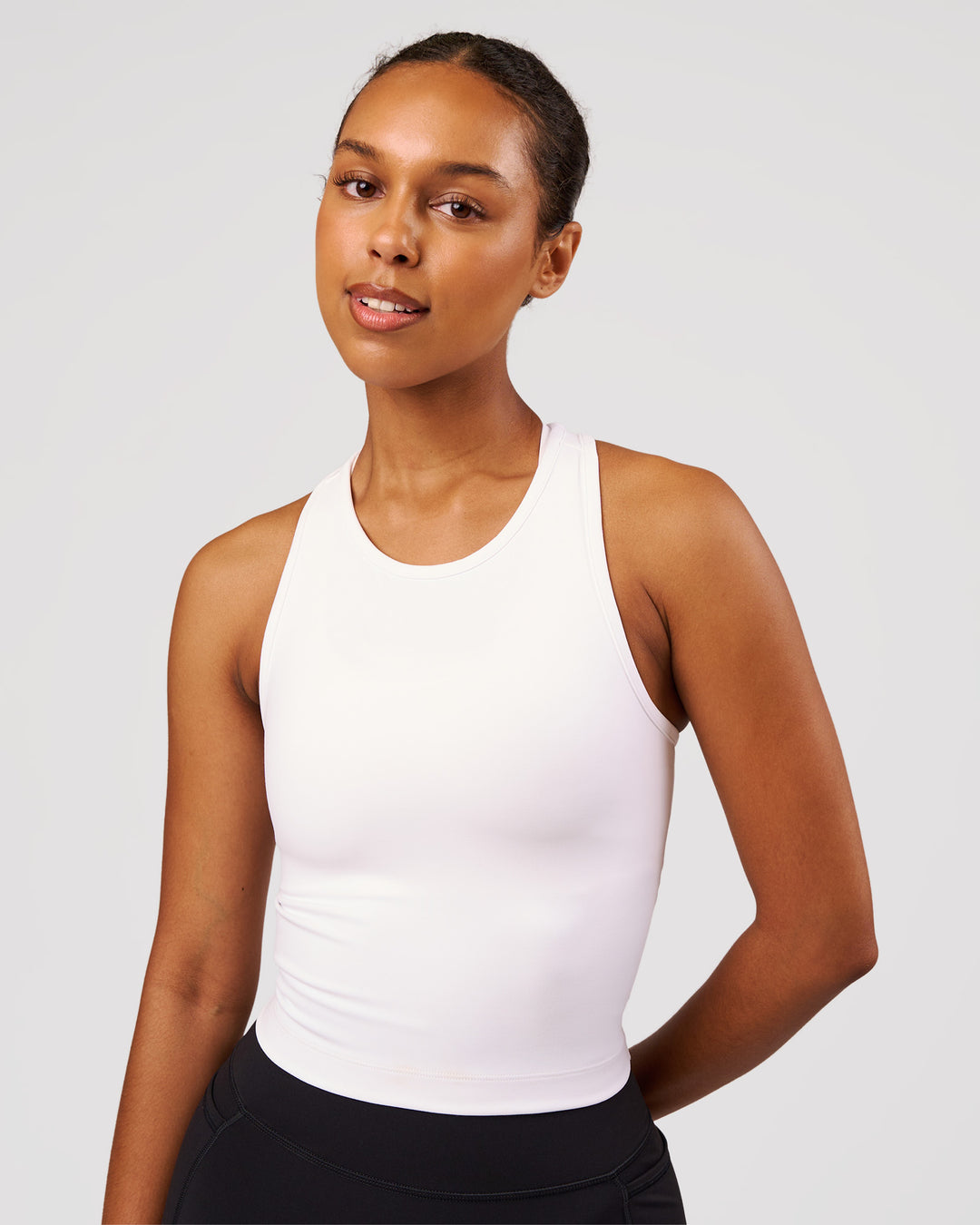 Woman wearing Flow Performance Tank 2.0 - White | Model:Jordan | Size:S - view 1