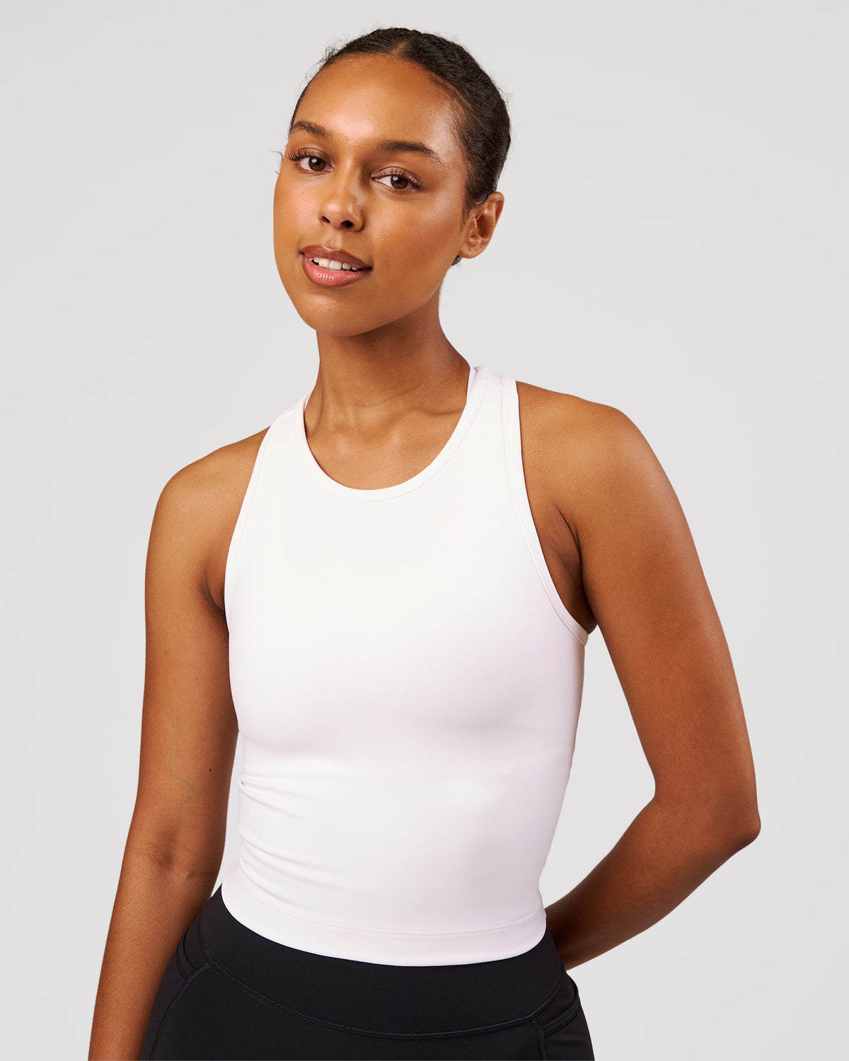 Woman wearing Flow Performance Tank 2.0 - White | Model:Jordan | Size:S