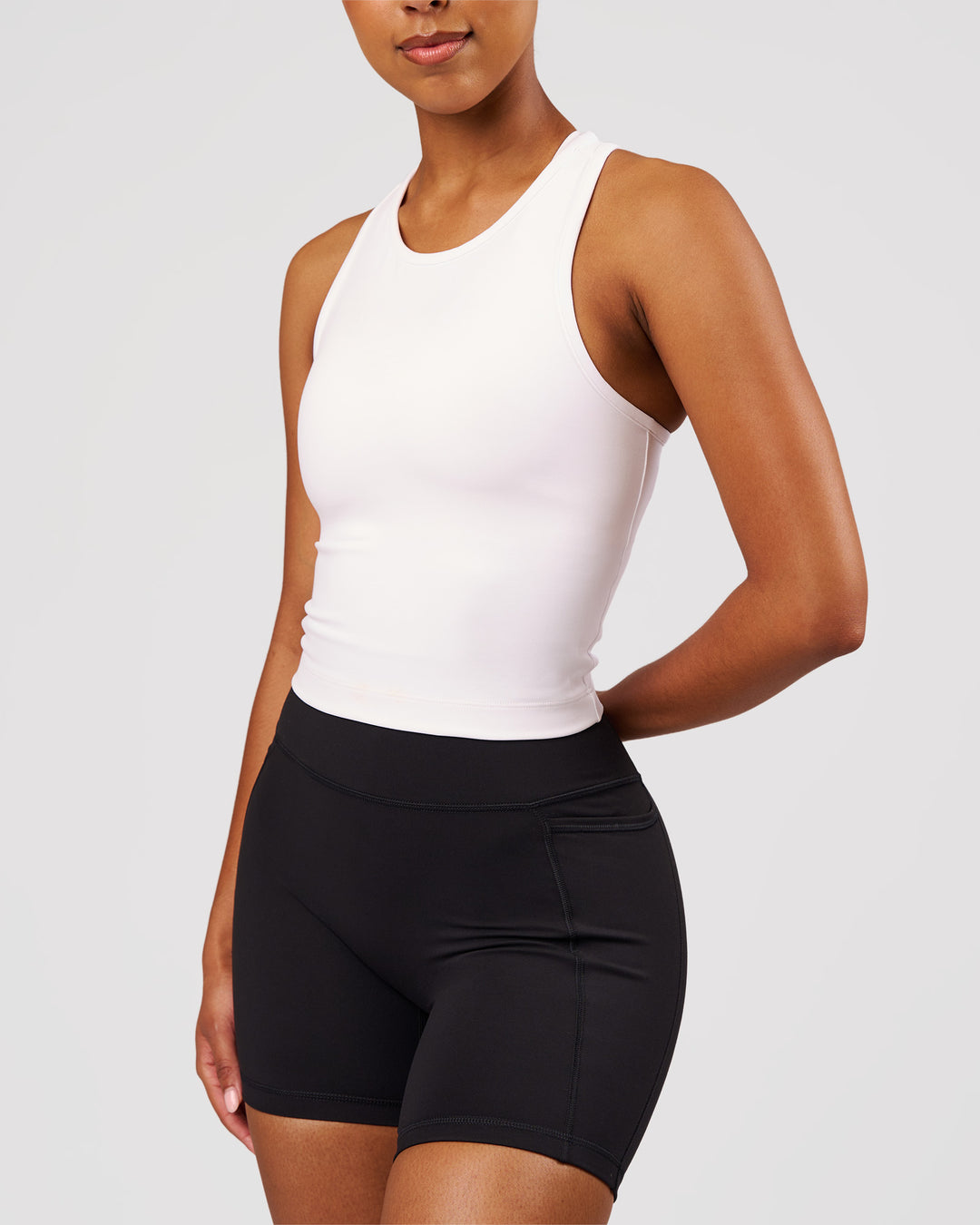 Woman wearing Flow Performance Tank 2.0 - White | Model:Jordan | Size:S - view 5