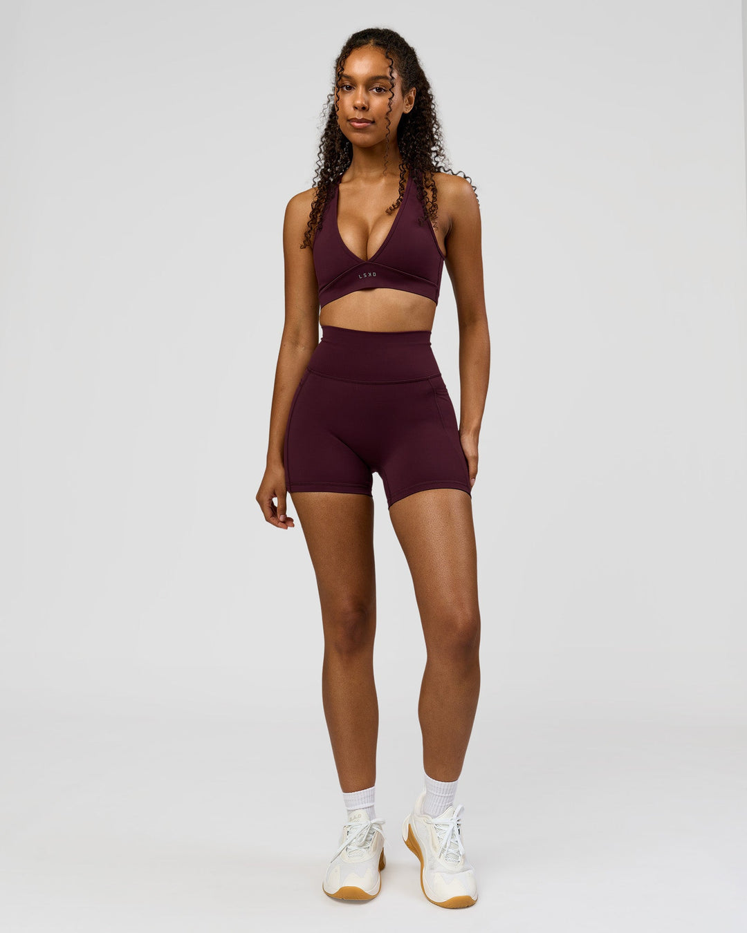 Woman wearing Fusion Ultra High-Rise 4" Short Pockets - Cherry Lacquer | Model:Jordan | Size:S - view 2
