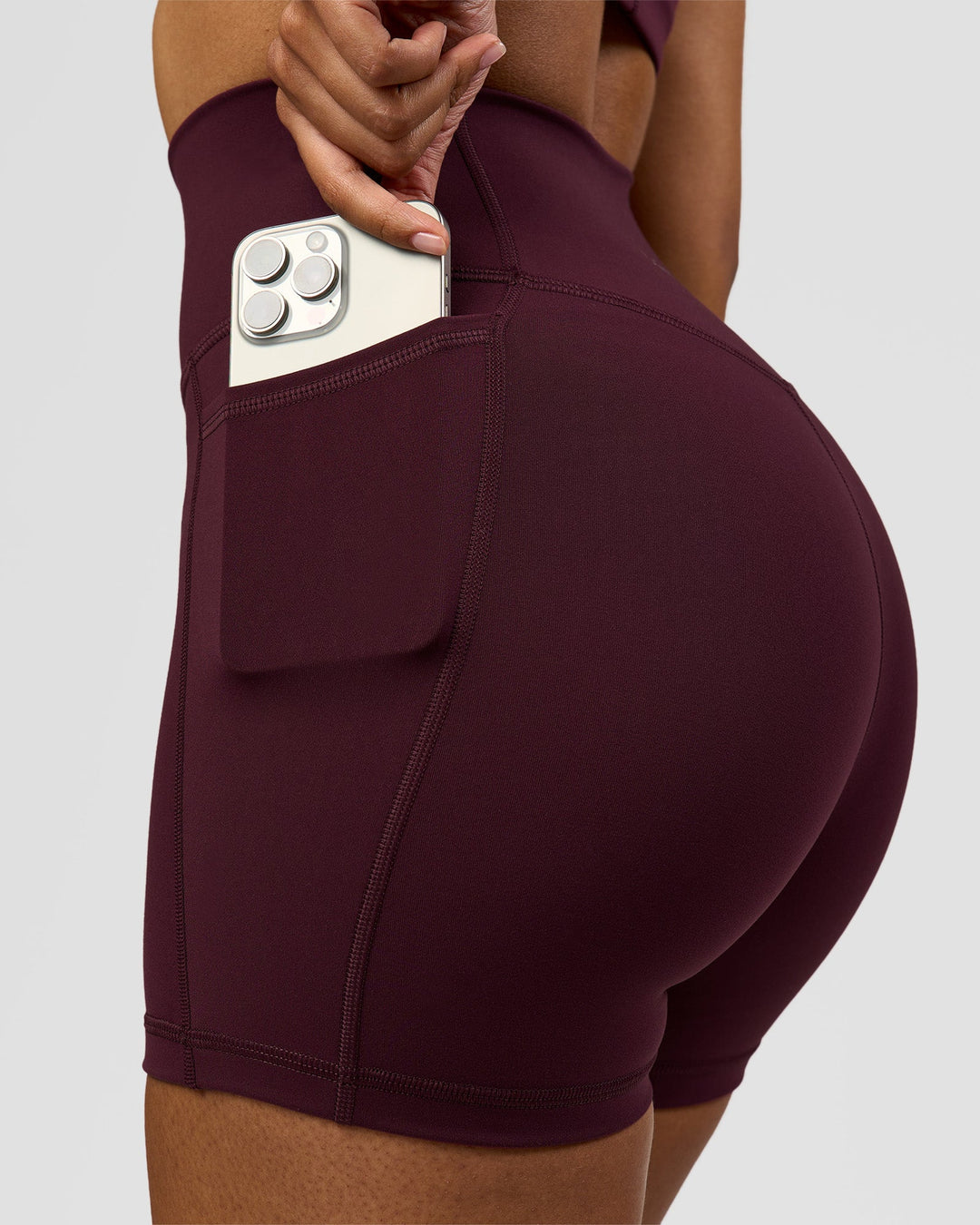 Woman wearing Fusion Ultra High-Rise 4" Short Pockets - Cherry Lacquer | Model:Jordan | Size:S - view 4
