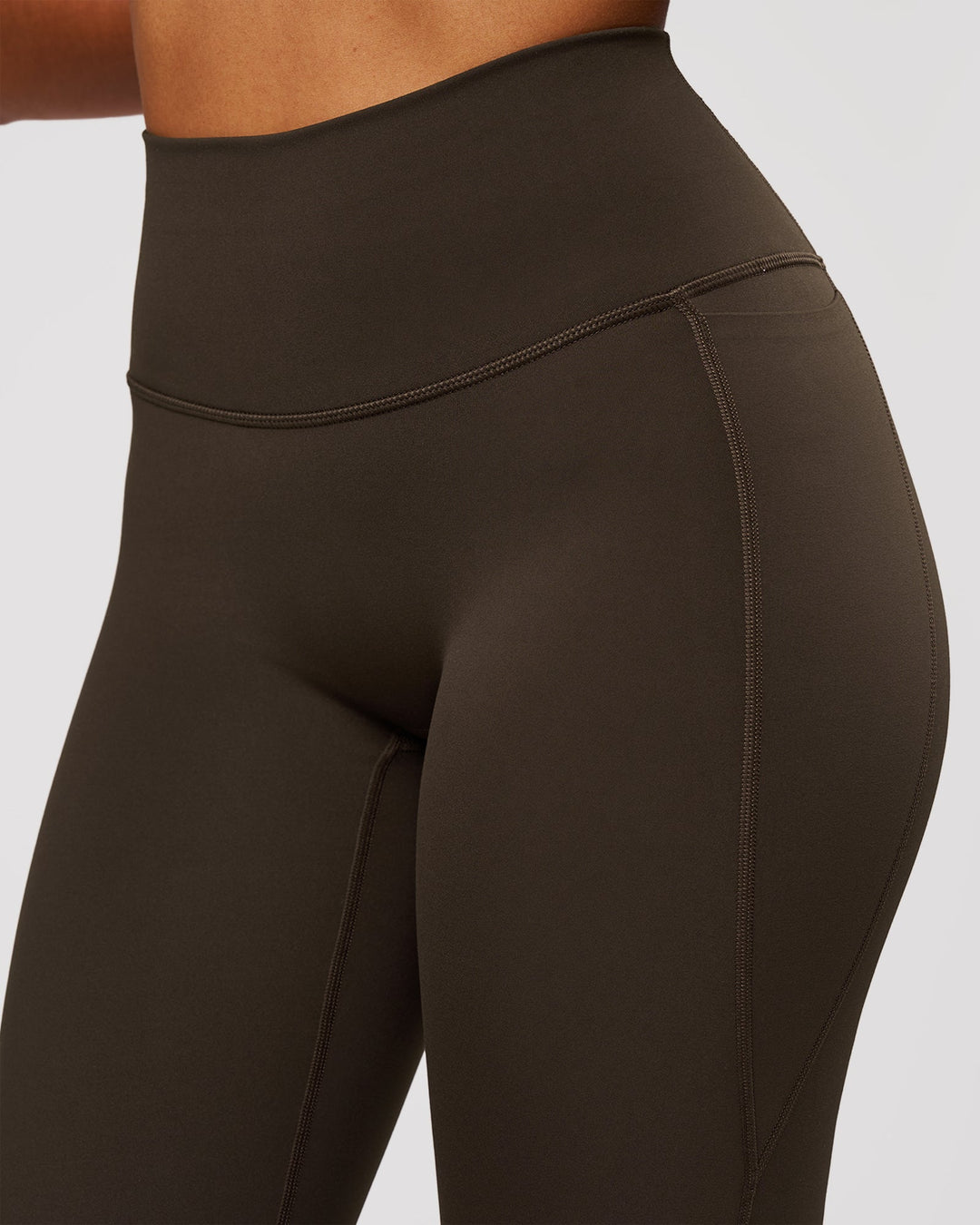 Woman wearing Fusion V-Contour High-Rise Flared Legging Pockets - Ground Coffee | Model:Jordan | Size:S - view 7