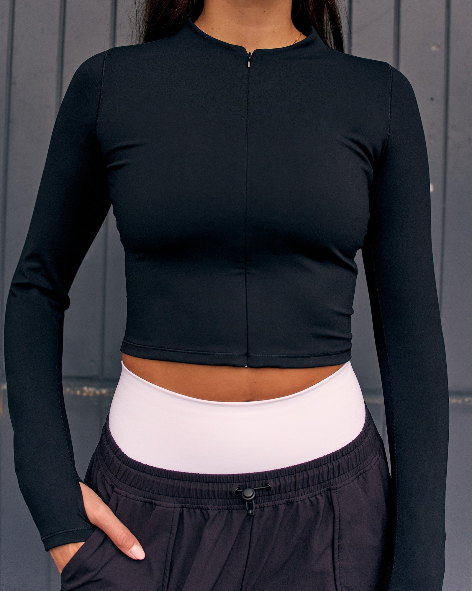Woman wearing Sculpt Full Zip Long Sleeve Top - Black | Model:Remy | Size:S