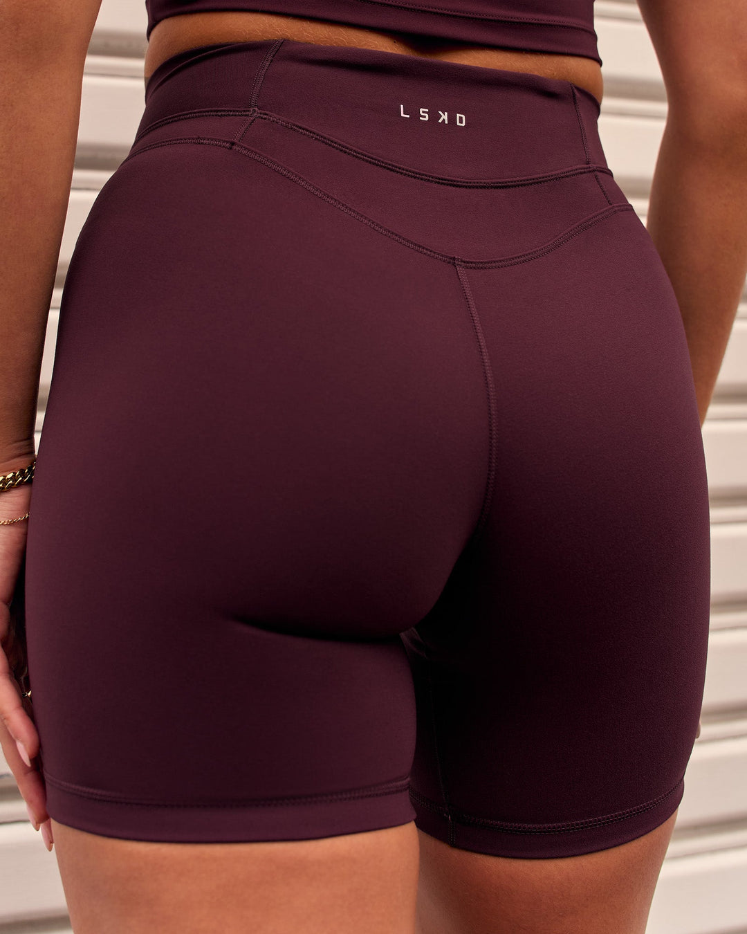 Woman wearing Solstice High-Rise 6" Short - Cherry Lacquer | Model:Remy | Size:S - view 2