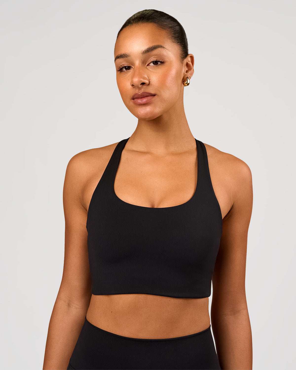 Woman wearing Flow Long Line Sports Bra - Black | Model:Rosie | Size:S - view 1