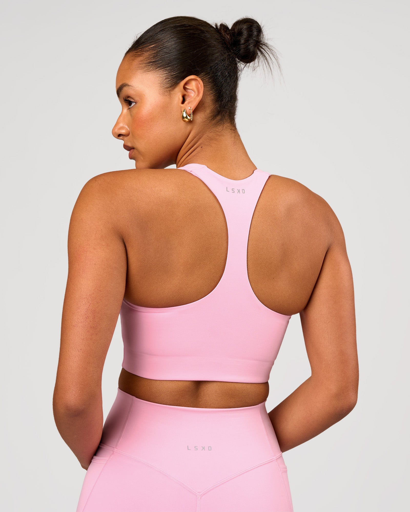 Woman wearing Flow Long Line Sports Bra - Pink Rose | Model:Rosie | Size:S