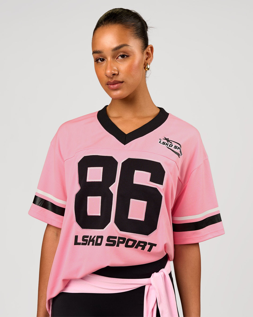 Woman wearing Playmaker V-Neck Jersey - Pink Rose-Black | Model:Rosie | Size:S - view 1