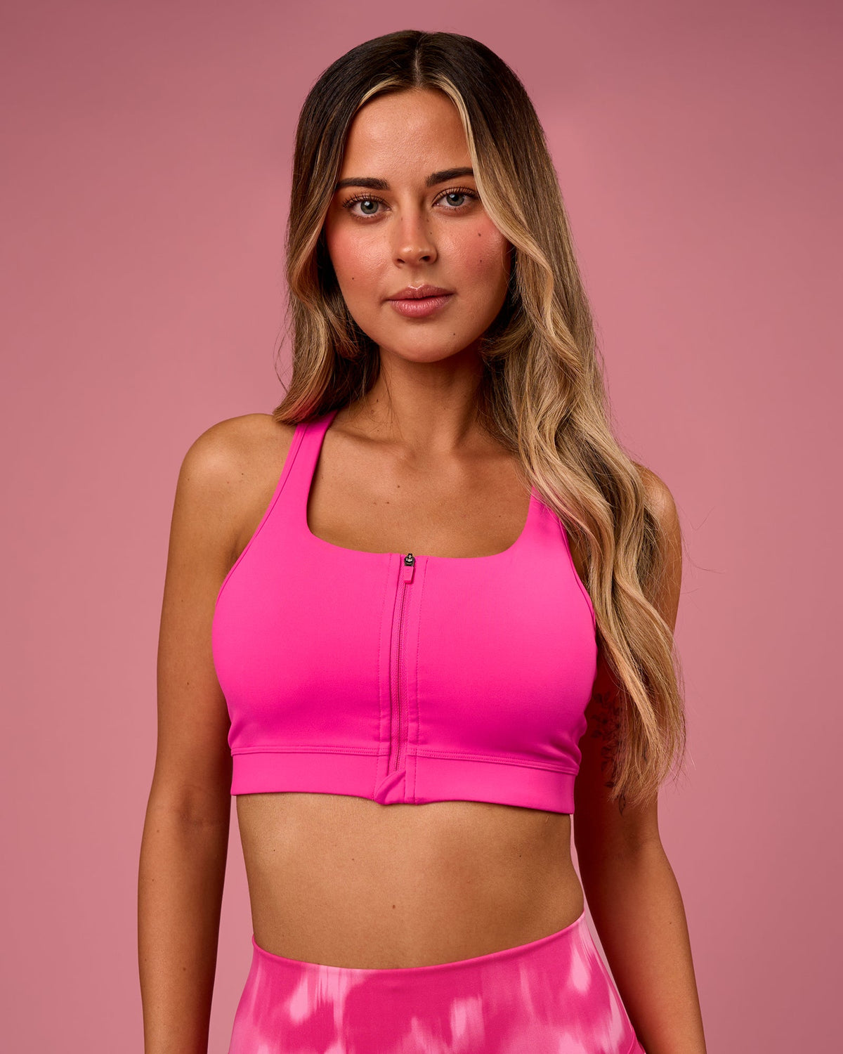 Woman wearing Empowered Sports Bra - Ultra Pink | Model:Tianah | Size:S - view 1