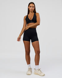 Woman wearing Fusion Bonded High-Rise 4" Short Pockets - Black | Model:Brylee | Size:XS | Thumbnail Index: 3