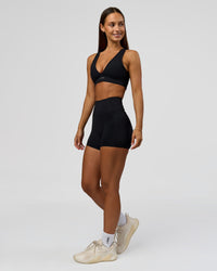 Woman wearing Fusion Bonded High-Rise 4" Short Pockets - Black | Model:Brylee | Size:XS | Thumbnail Index: 4