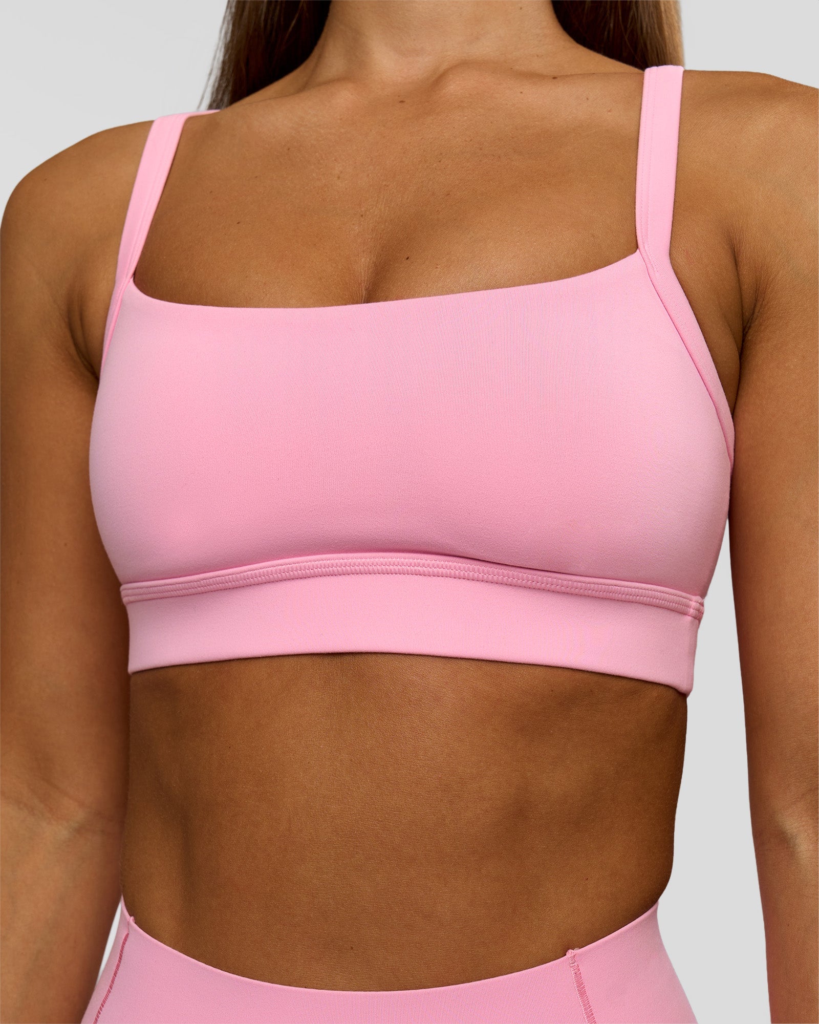 Woman wearing Momentum Sports Bra - Pink Rose | Model:Brylee | Size:XS